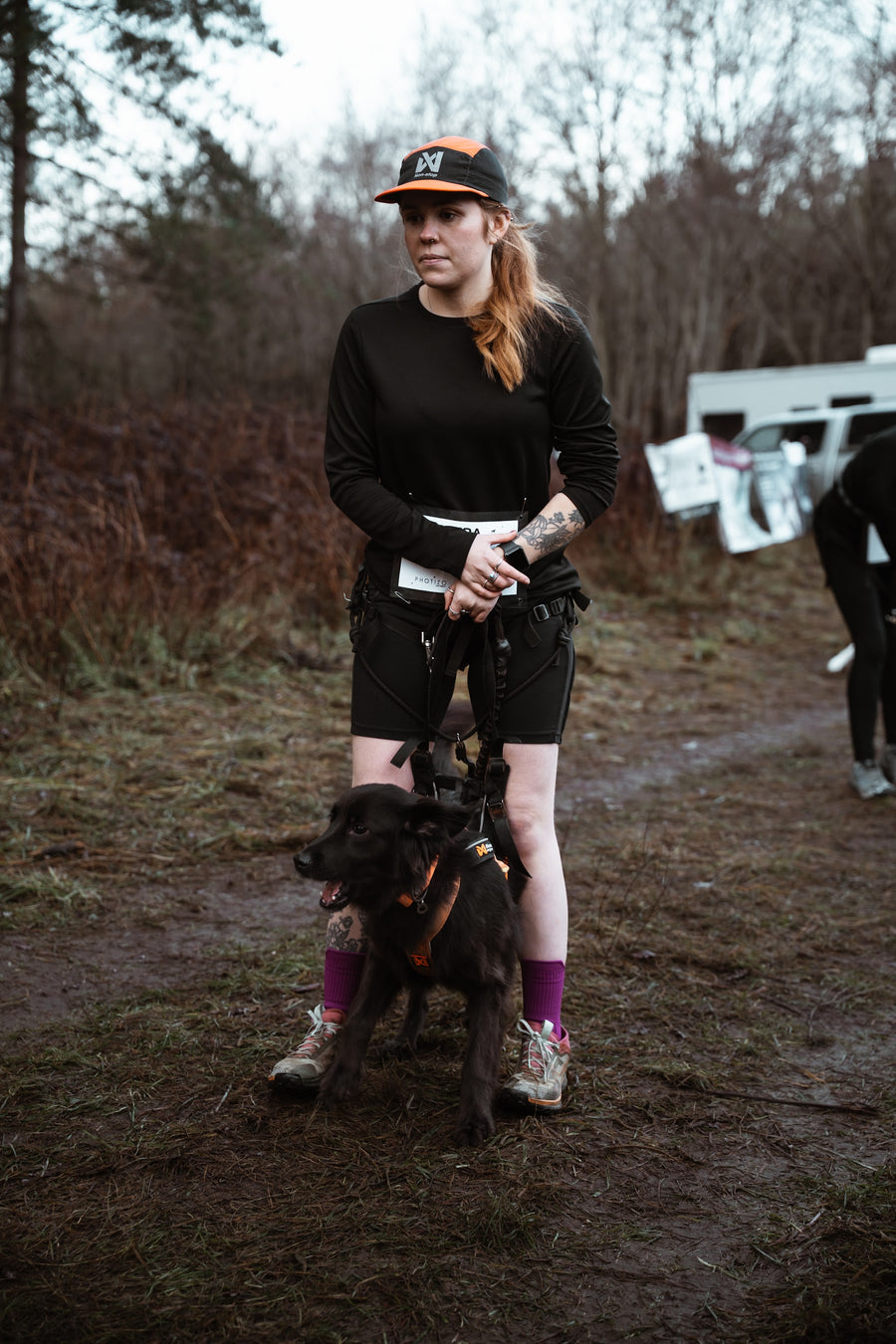 Runner and dog ready at a canicross race